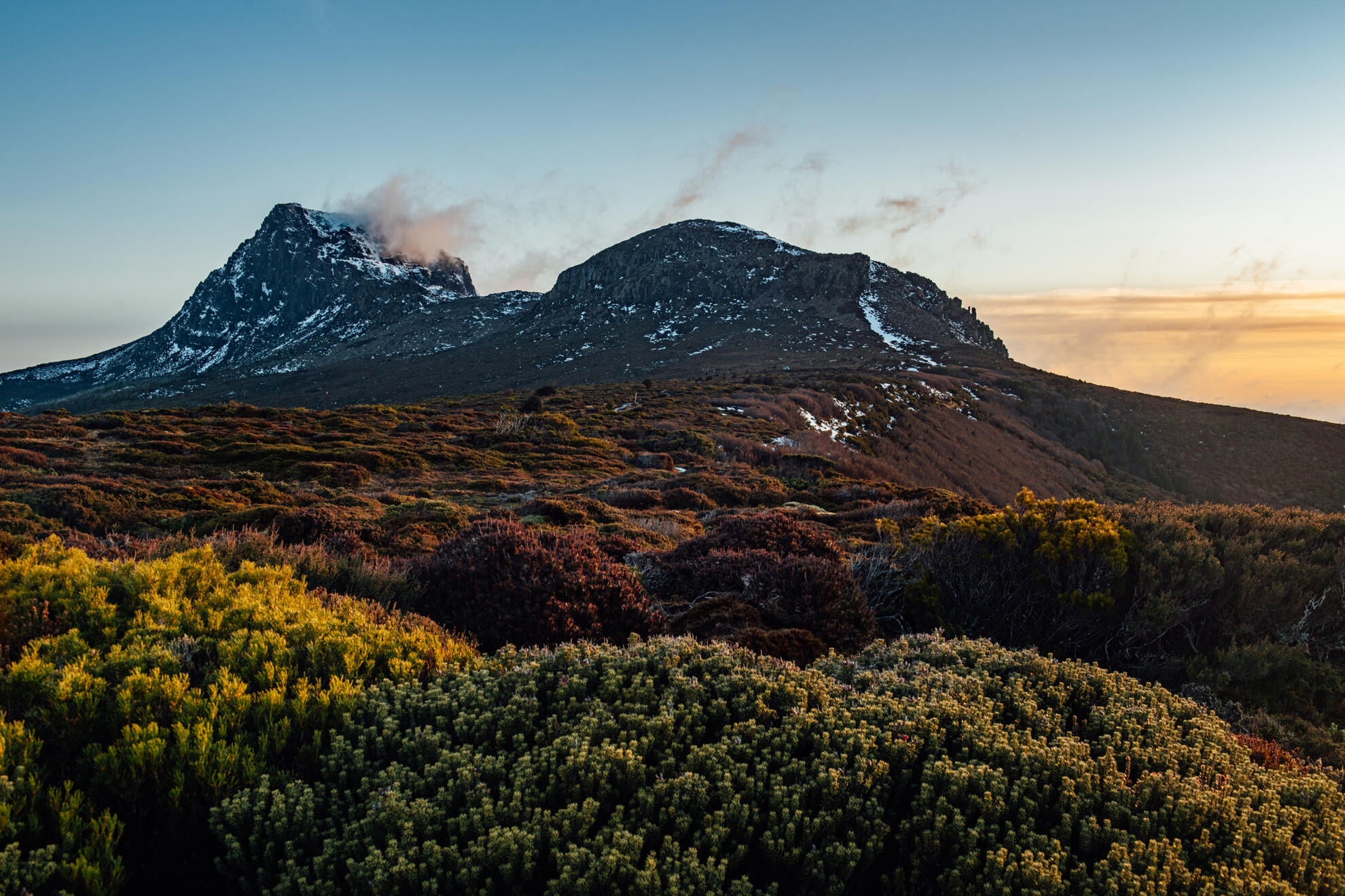 Misty clouds rolling over the rugged dolerite peaks of Cradle Mountain-St Clair National Park.